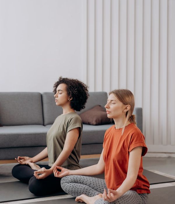 Serene pregnant woman practicing yoga in a bright, calm room.